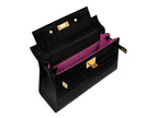 Inside of a large black, ‘croc’ print Italian calf leather handbag with top handle, detachable strap and gold plated hardware featuring the bright pink suede interior