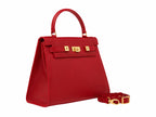 A red Italian natural print leather handbag with a top handle and a detachable shoulder strap, featuring gold-plated hardware and magnetic locks.