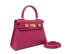 A bright pink, medium-sized, grainy print Italian calf leather handbag with gold-plated hardware, detachable strap and a top handle.