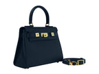 Navy blue Italian leather handbag with gold hardware, a top handle and a detachable strap on a white background
