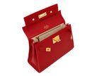 A bright red, medium-sized Italian leather handbag with a pebble print and gold-plated hardware, featuring a top handle and a detachable shoulder strap.