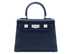 Medium navy blue natural grain Italian leather handbag with a hint of silver sparkle with silver hardware, a top handle and a detachable strap on a white background
