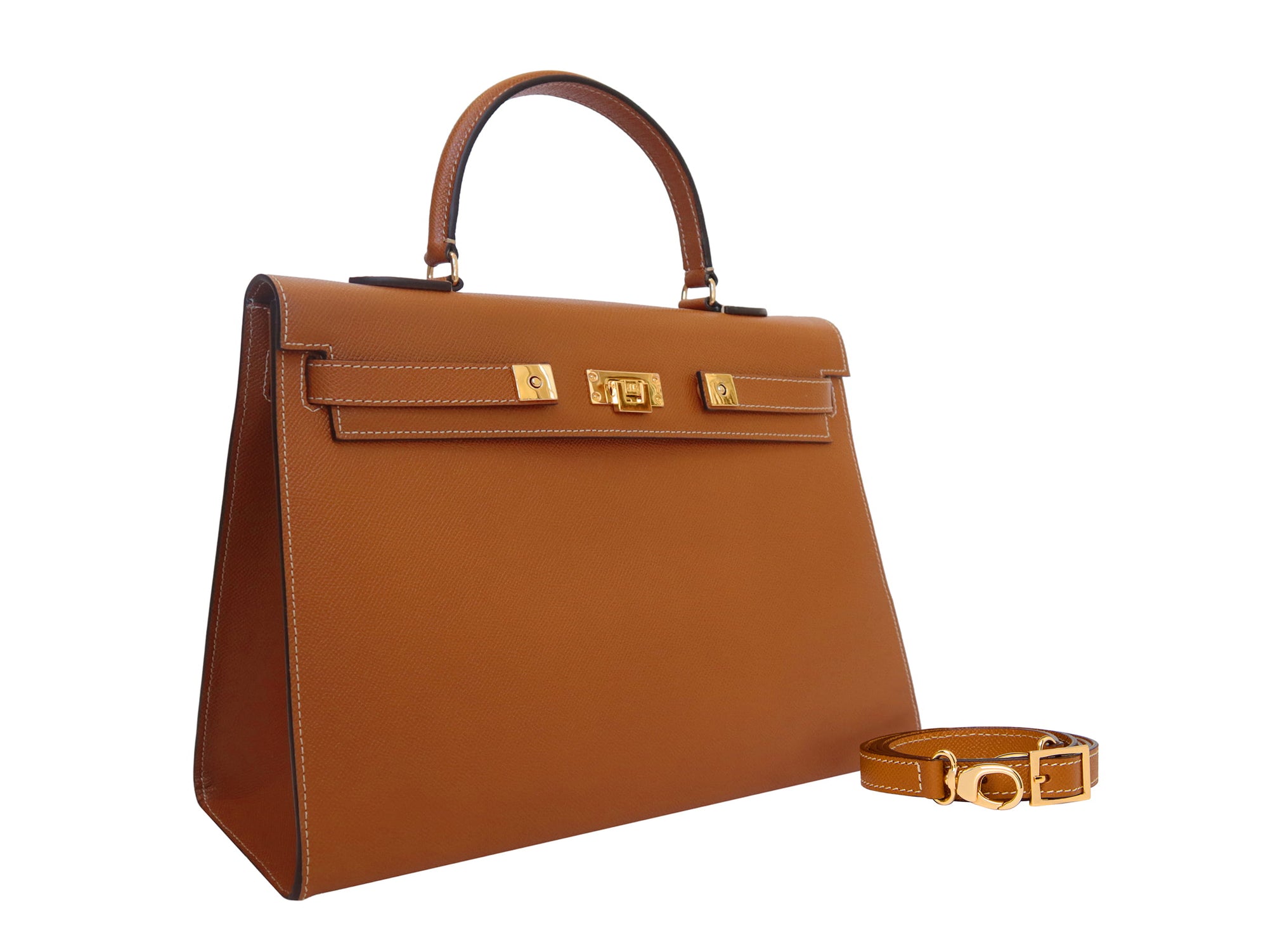 A large tan colored Italian calf leather handbag with pebble print texture, gold plated hardware, and a top handle with a detachable strap.