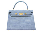 A large pale blue , ‘croc’ print Italian calf leather handbag with top handle, detachable strap and gold plated hardware