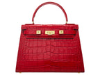 A large red, ‘croc’ print Italian calf leather handbag with top handle, detachable strap and gold plated hardware.
