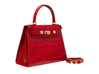 A large red, ‘croc’ print Italian calf leather handbag with top handle, detachable strap and gold plated hardware.