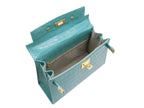 Inside of a large turquoise , ‘croc’ print Italian calf leather handbag with top handle, detachable strap and gold plated hardware showing the grey suede lined interior.