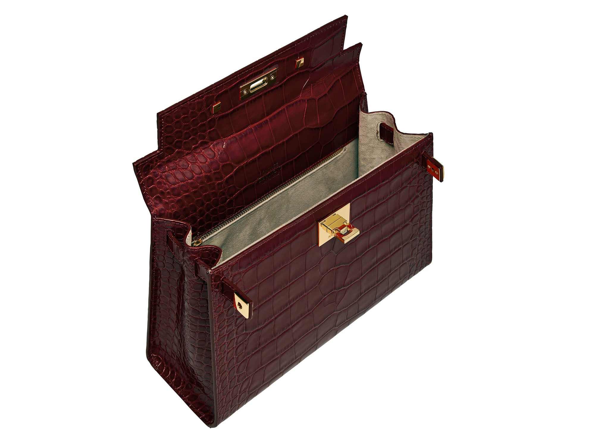 Inside of a large wine ‘croc’ print Italian calf leather handbag with top handle, detachable strap and gold plated hardware with magnetic fastening showing suede lined interior
