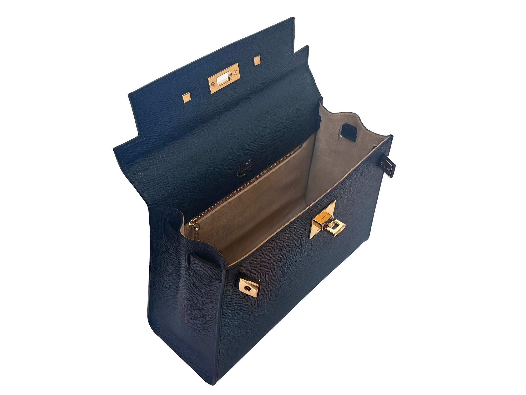 Inside of a large navy Italian leather, natural print handbag with gold hardware, a top handle with a detachable strap on a white background.