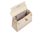 Inside view of a beige Italian leather handbag with gold hardware on a white background