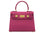 A bright pink, medium-sized, grainy print Italian calf leather handbag with gold-plated hardware, detachable strap and a top handle.