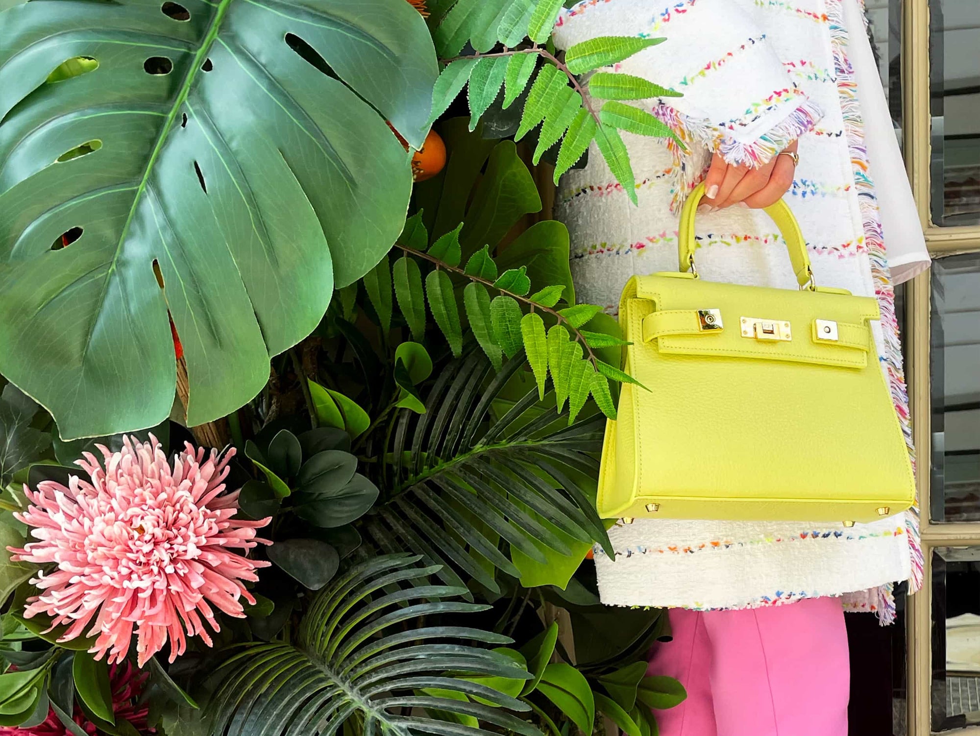 A bright yellow luxury Italian leather natural soft grain handbag with a top handle, detachable strap and gold-plated hardware, positioned against a plain background.