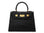 Black ‘crocodile print’ handbag with gold hardware on a white background