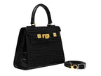 Black ‘crocodile print’ handbag with gold hardware on a white background