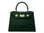Green ‘croc’ print handbag with gold hardware on a white background