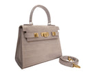 Stone handbag with gold hardware on a white background