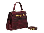 A burgundy wine coloured 'Croc' print Italian calf leather handbag with gold plated hardware, a top handle and a detachable strap.