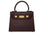 Medium chocolate brown Italian leather handbag with gold hardware, a top handle and a detachable strap on a white background