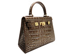 A bronze croc print Italian calf leather luxury handbag with gold plated hardware and a top handle.